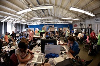 TechShop space showing multiple teams working on computer and other equipment TechShop space showing multiple teams working on computer and other equipment