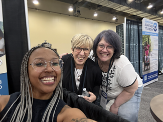 3 women smiling at camera 