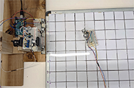 This overhead photo shows the testing set up for the receiving array and the mobile transmitter. The receiving array and mobile transmitter were tested in the 600 by 900 millimeter grid.
