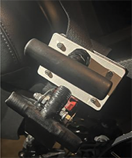 Final product mounted together to vehicle seatbelt system.  Shows how both T-handles are within reach of driver.
