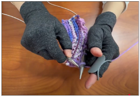 KnitGrip being used to create a sample swatch of knitting.