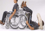 There are two pictures within the picture of a person demonstrating the activation of the &ldquo;Pop&rdquo; system during a backward fall. First picture user sits upright in the wheelchair and second pictures user lies backward on the floor with head protected by inflated airbag. 