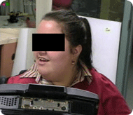 This photograph shows a video close up of an expert user&rsquo;s face with embedded video in the upper left hand corner of the robot she is looking at.