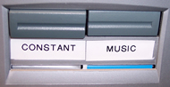 Image displays AV selector switch utilized to transition between constant vibration and music-synchronized vibration.  The selector has two buttons labeled &ldquo;Constant&rdquo; and &ldquo;Music.&rdquo;
